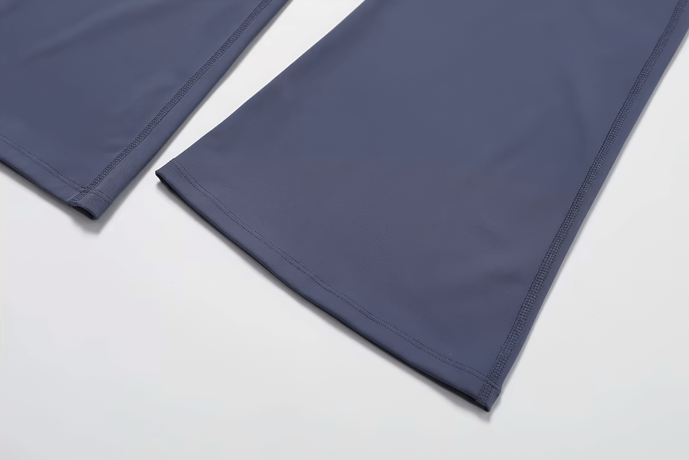 Close-up of navy high-waist flared yoga pants for women, showcasing stylish bell-bottom design and premium fabric blend.