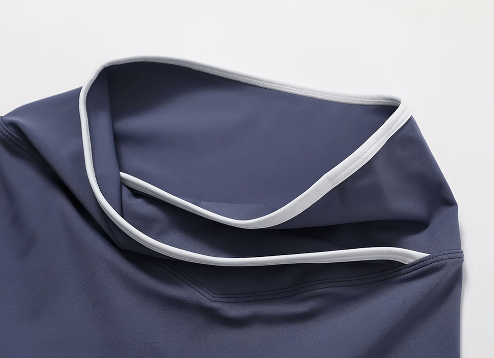 Close-up of stylish high-waist flared yoga pants in navy blue with white trim, showcasing elastic waist and premium fabric blend.