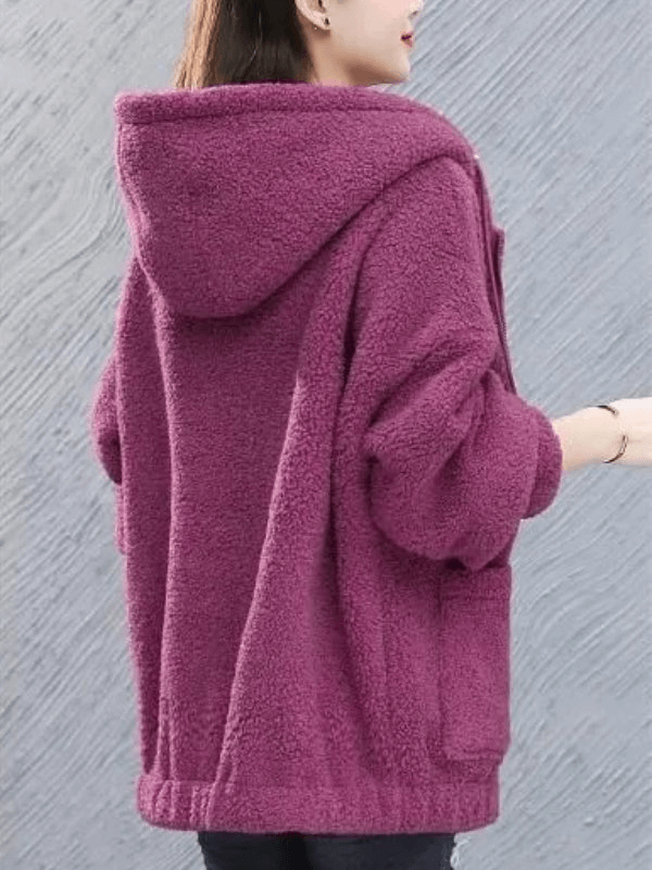 Woman wearing a stylish loose fleece jacket with hood, in soft purple, showcasing casual and cozy design.