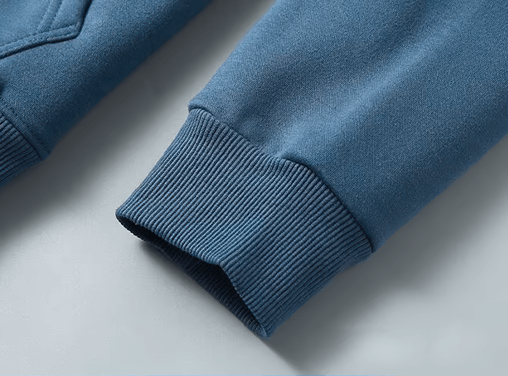 Close-up of blue fleece lined hoodie sleeve, showcasing ribbed cuff detail for stylish men's casual wear.