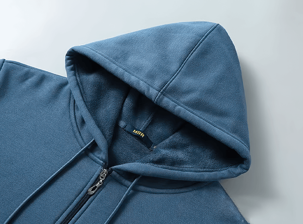 Close-up of a stylish men's casual zip-up fleece lined hoodie in blue, showcasing hood and zipper details.