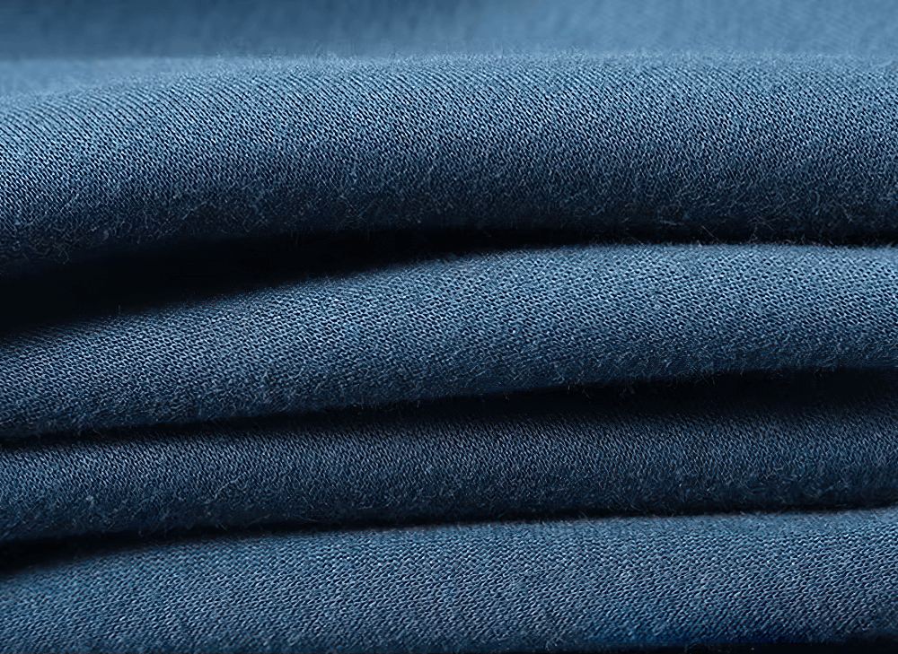 Close-up of blue fleece fabric showcasing texture and color, perfect for cozy zip-up hoodies.