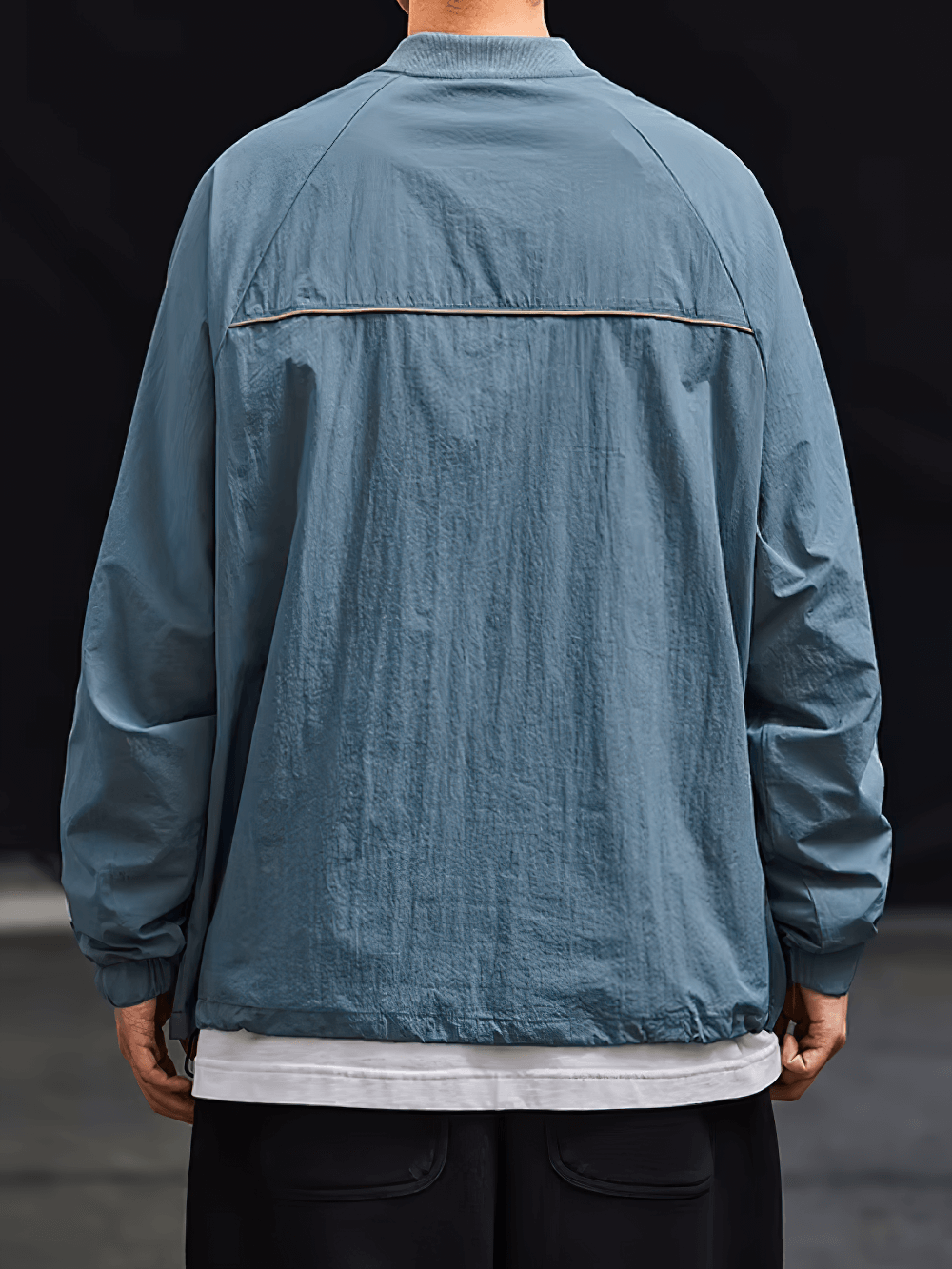 Back view of a blue lightweight men's zip sports jacket with modern design, ideal for casual outings and sports activities.