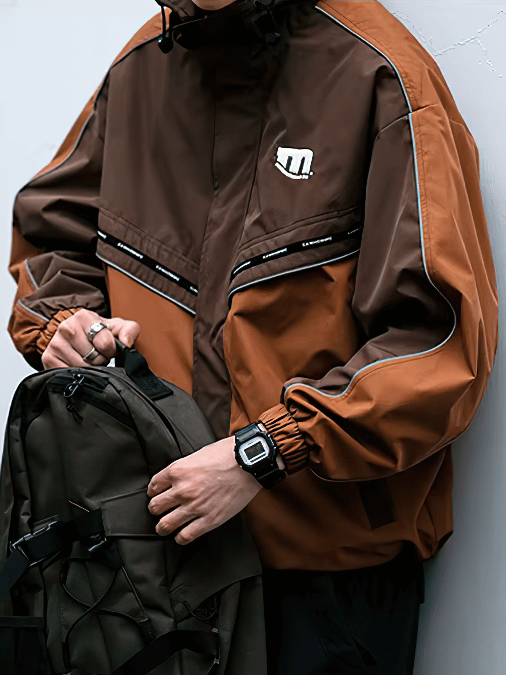 Stylish men's outdoor reflective hooded jacket SF2273 with patchwork design, zipper closure, ideal for sports and outdoor activities.