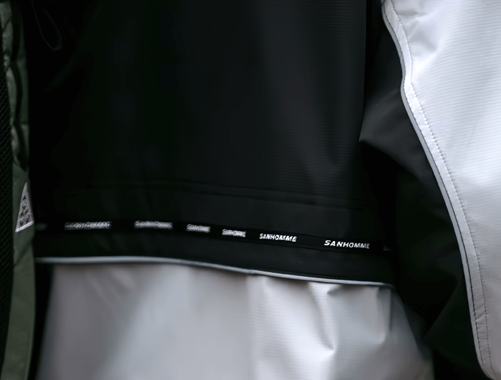 Close-up of Stylish Men's Outdoor Reflective Hooded Jacket SF2273 with patchwork design and reflective accents for sportswear.