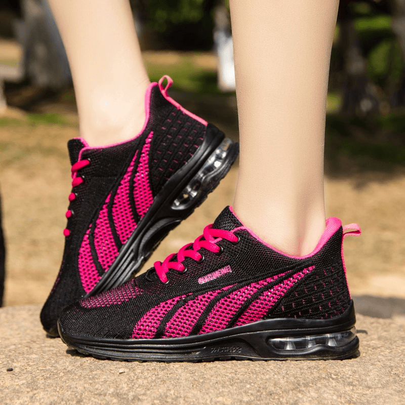 Woman wearing stylish mesh flexible lace-up sneakers SF1414 with a black and pink design, ideal for active lifestyles.