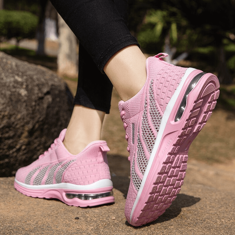 Stylish pink mesh lace-up women's sneakers SF1414 with low upper height and cushioning soles for comfort on a nature walk.
