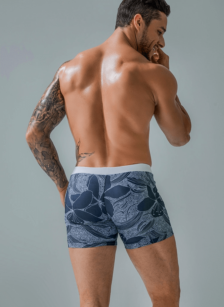 Back view of man wearing stylish quick dry men's swim shorts SF1295 with floral print and pockets, showcasing comfort and fit.
