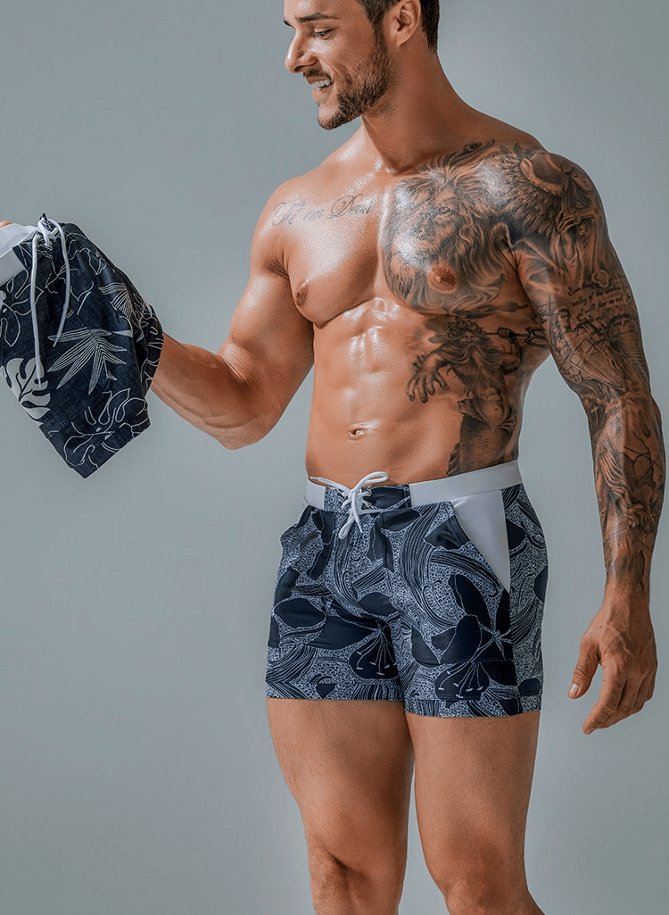 Stylish quick dry men's swim shorts with pockets featuring a trendy print, perfect for beach days and outdoor activities.