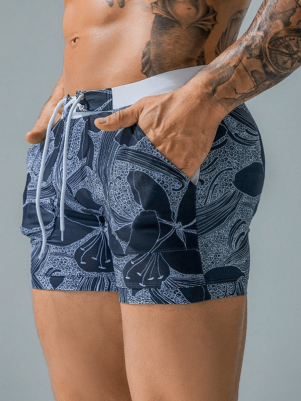 Stylish quick-dry men's swim shorts with pockets featuring a trendy print design, perfect for beach days and outdoor activities.