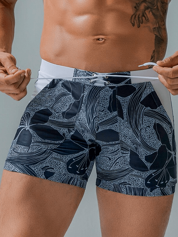 Stylish quick-dry men's swim shorts with pockets, featuring a fashionable print design and adjustable waistband, perfect for beach days.