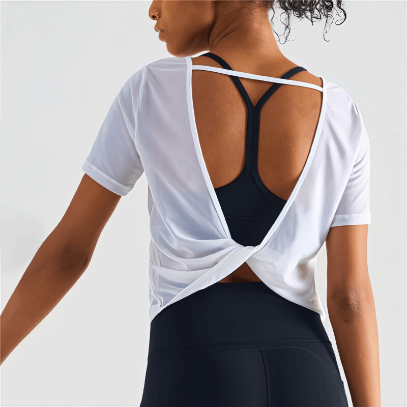 Alt Tag: Woman wearing stylish open back quick-drying sports T-shirt made of breathable nylon, perfect for workouts or casual wear.