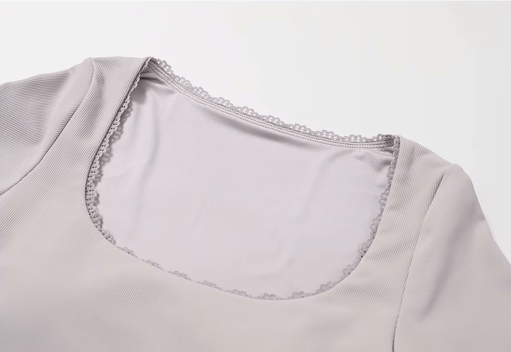 Stylish ribbed women's yoga top, long-sleeved and light gray, perfect for running, fitness, cycling, hiking, and camping activities.