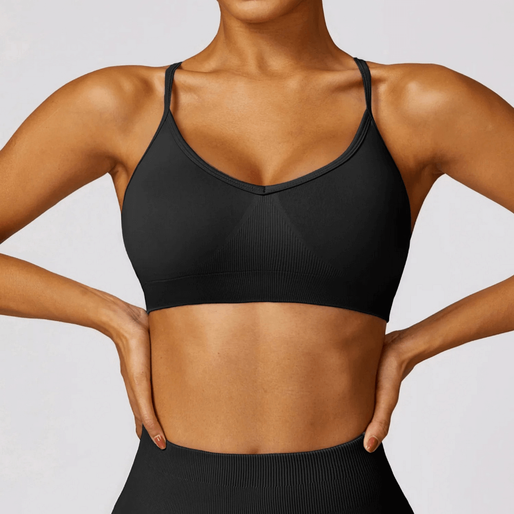 Alt Tag: Stylish seamless black yoga bra with criss-cross straps, offering high support for workouts and sports, model SF2452.