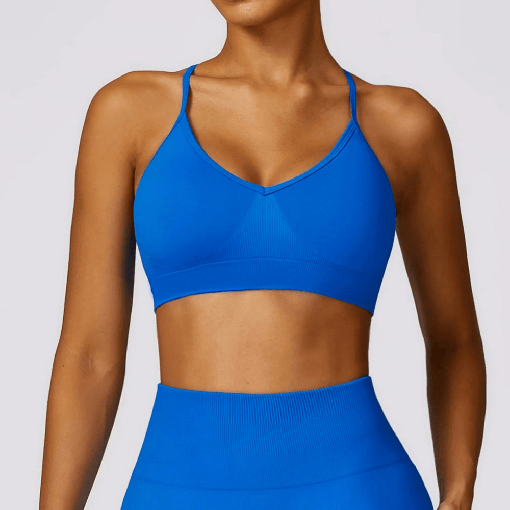 Stylish seamless blue yoga bra SF2452 with criss-cross straps for high support in fitness, yoga, and dance. Quick-dry technology.