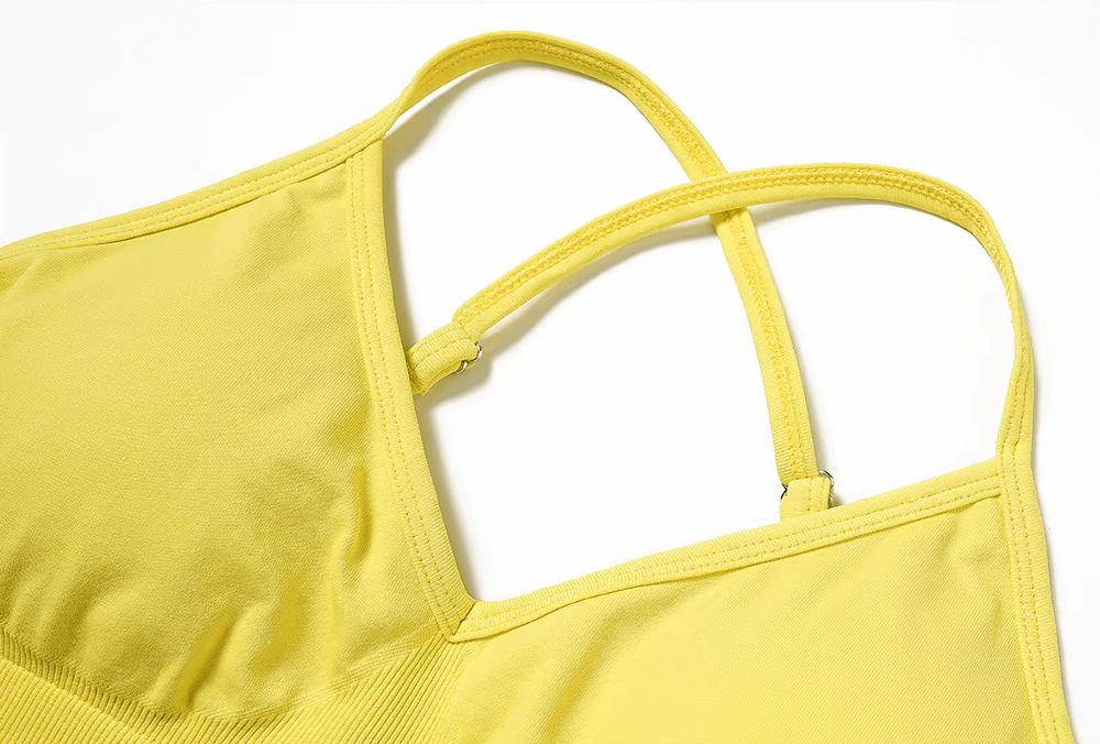 Yellow seamless yoga bra with criss-cross straps, providing high support and breathable material for yoga and active lifestyles.