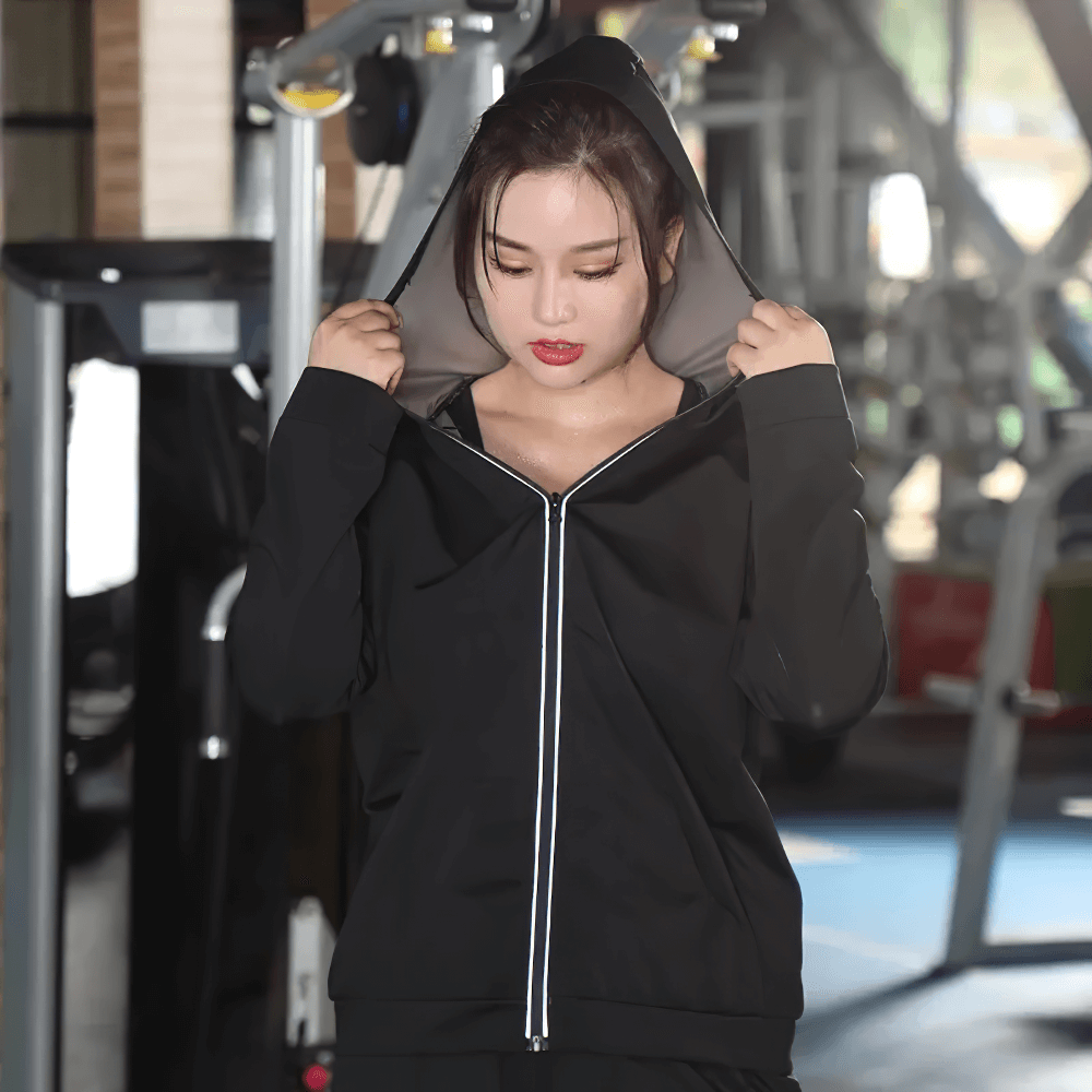 Woman in gym wearing Stylish Set Hooded Jacket and Pants, SF2247, designed for efficient sweating and weight loss during workouts.