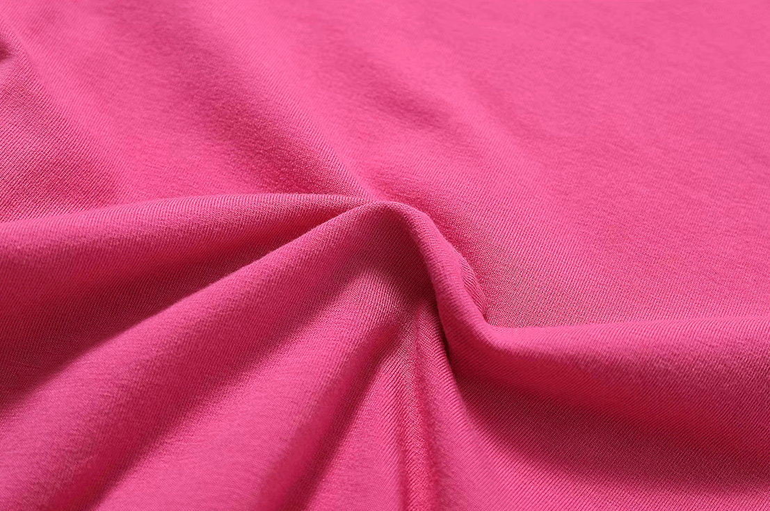 Close-up of pink cotton and spandex fabric for women's short-sleeve yoga T-shirt SF2418, showcasing sleek design and elastic flexibility.