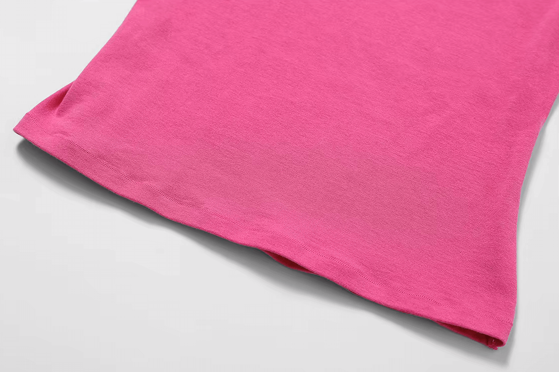 Close-up of pink short-sleeve yoga T-shirt fabric showcasing stretchy, breathable material ideal for fitness and yoga.
