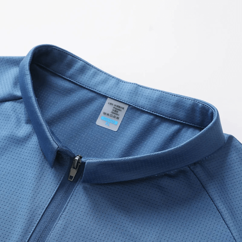 Close-up of a men's solid color blue sports polo shirt with a zip closure, made from breathable polyester and spandex blend.