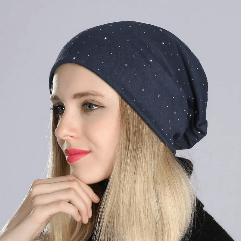 Stylish solid color women's beanie with rhinestones on blonde woman, perfect for a casual look. Made of lightweight polyester.