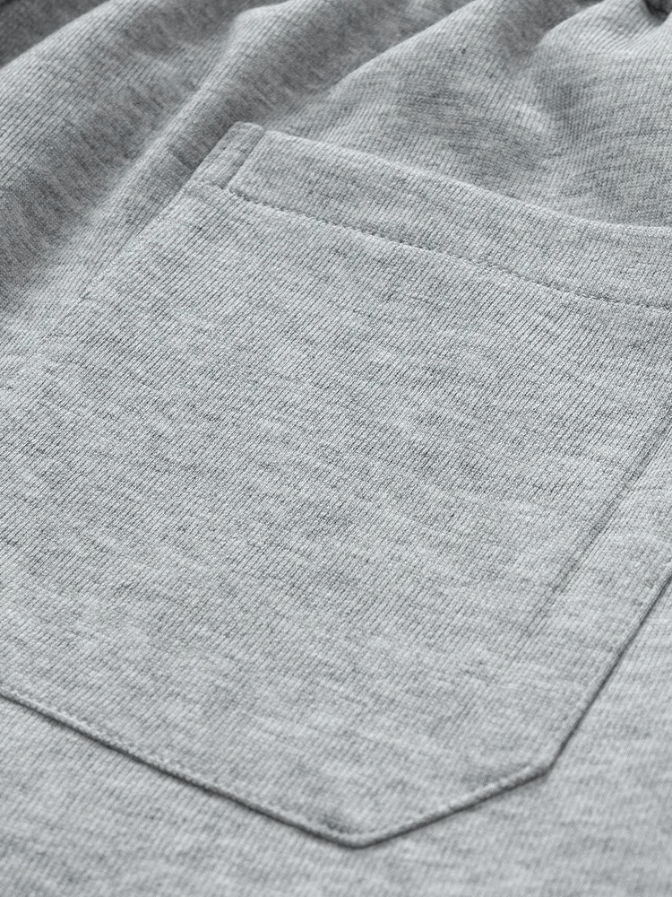 Close-up of gray stylish sports men's pants pocket, showcasing durable polyester-cotton material and secure stitching.