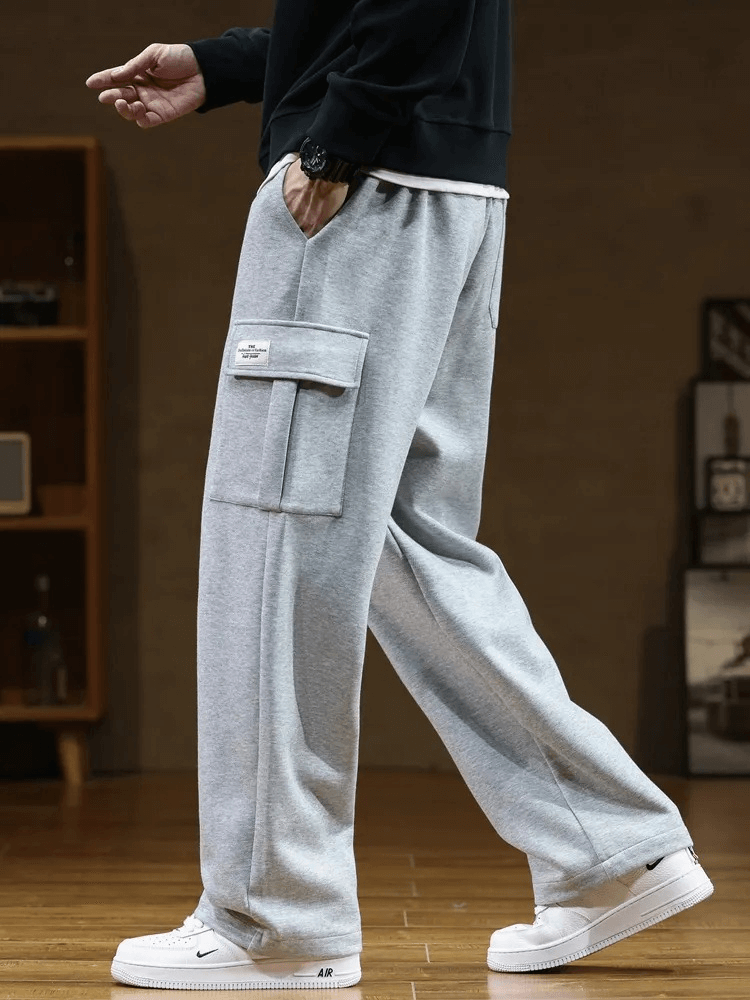 Stylish men's sports pants SF1977, gray, with several pockets, midrise waist, loose fit, durable polyester-cotton blend.