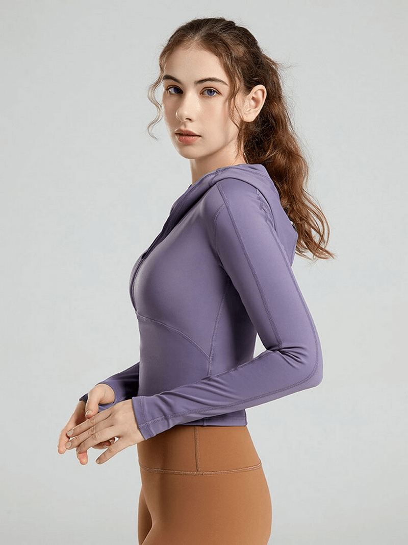 Stylish women's sports top with long sleeves and hood, perfect for yoga; breathable, quick-dry nylon and spandex fabric in purple.