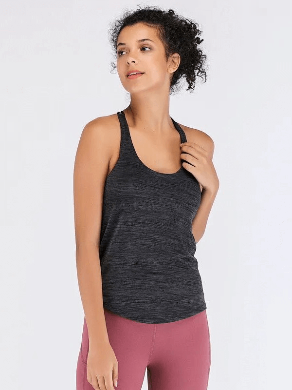 Woman wearing a black sporty tank top with open back, ideal for yoga or workouts, featuring quick-dry nylon and polyester blend.
