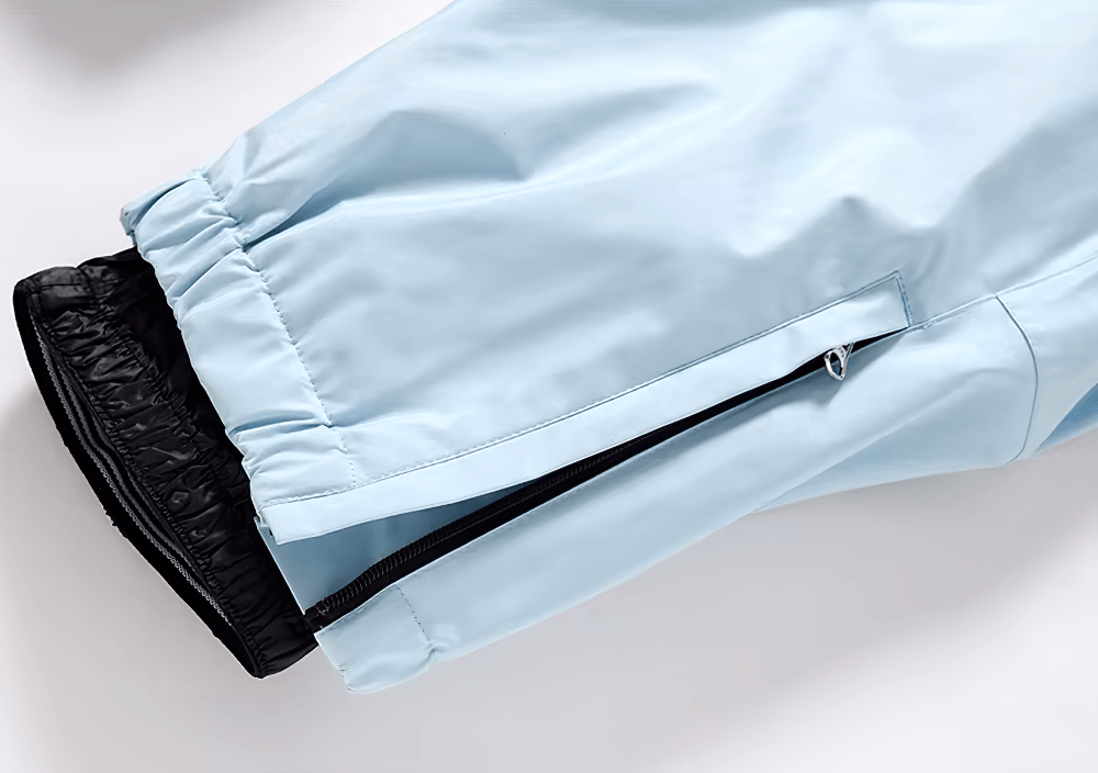 Light blue ski pants with black inner cuff and zipper, part of a stylish unisex waterproof snowboarding set, perfect for outdoor sports.