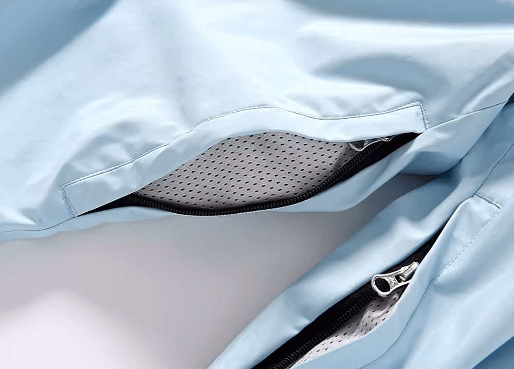 Close-up of waterproof blue ski jacket with zippered ventilation opening.