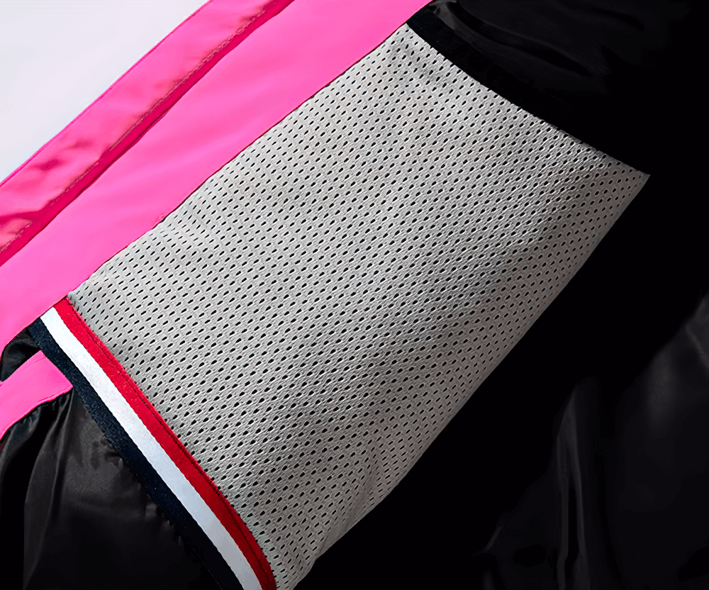 Close-up of the mesh lining inside a stylish unisex ski jacket, featuring pink detailing and breathable fabric design.