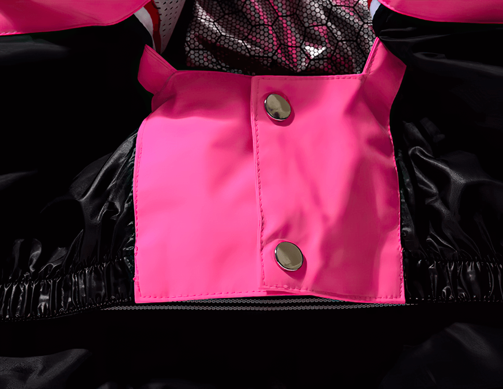 Close-up of waterproof ski jacket with pink and black detailing, showing button closures for stylish unisex protection against winter weather.