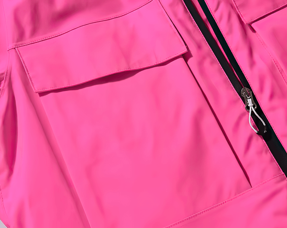 Bright pink waterproof ski jacket with front zipper and pocket detail, perfect for skiing and snowboarding.