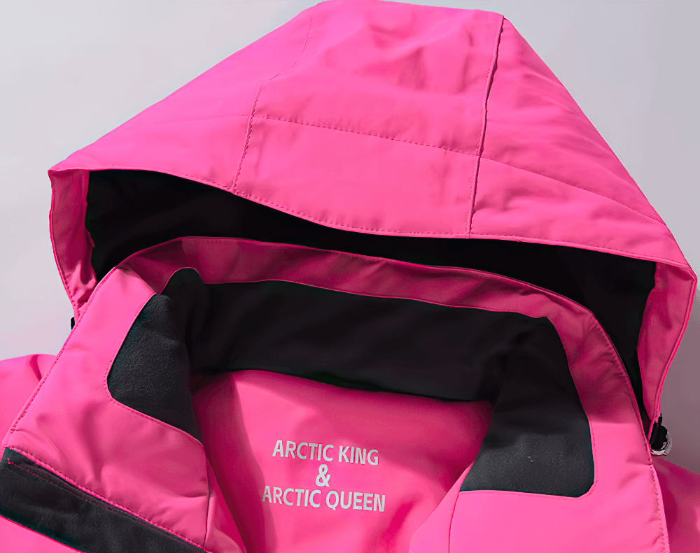 Stylish pink unisex waterproof ski jacket with hood displaying the brand text 'Arctic King & Arctic Queen' on the inner collar.