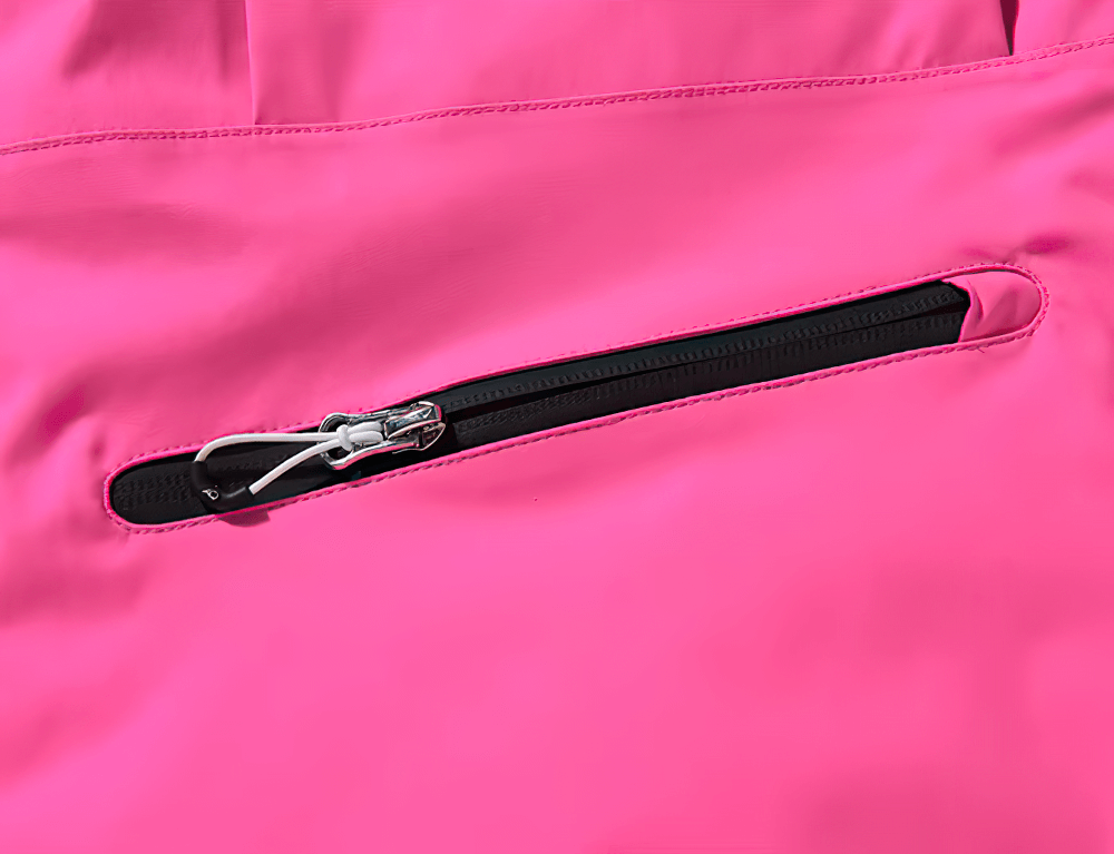 Close-up of a pink waterproof ski jacket pocket with a black zipper, showcasing durable outdoor sportswear detail.