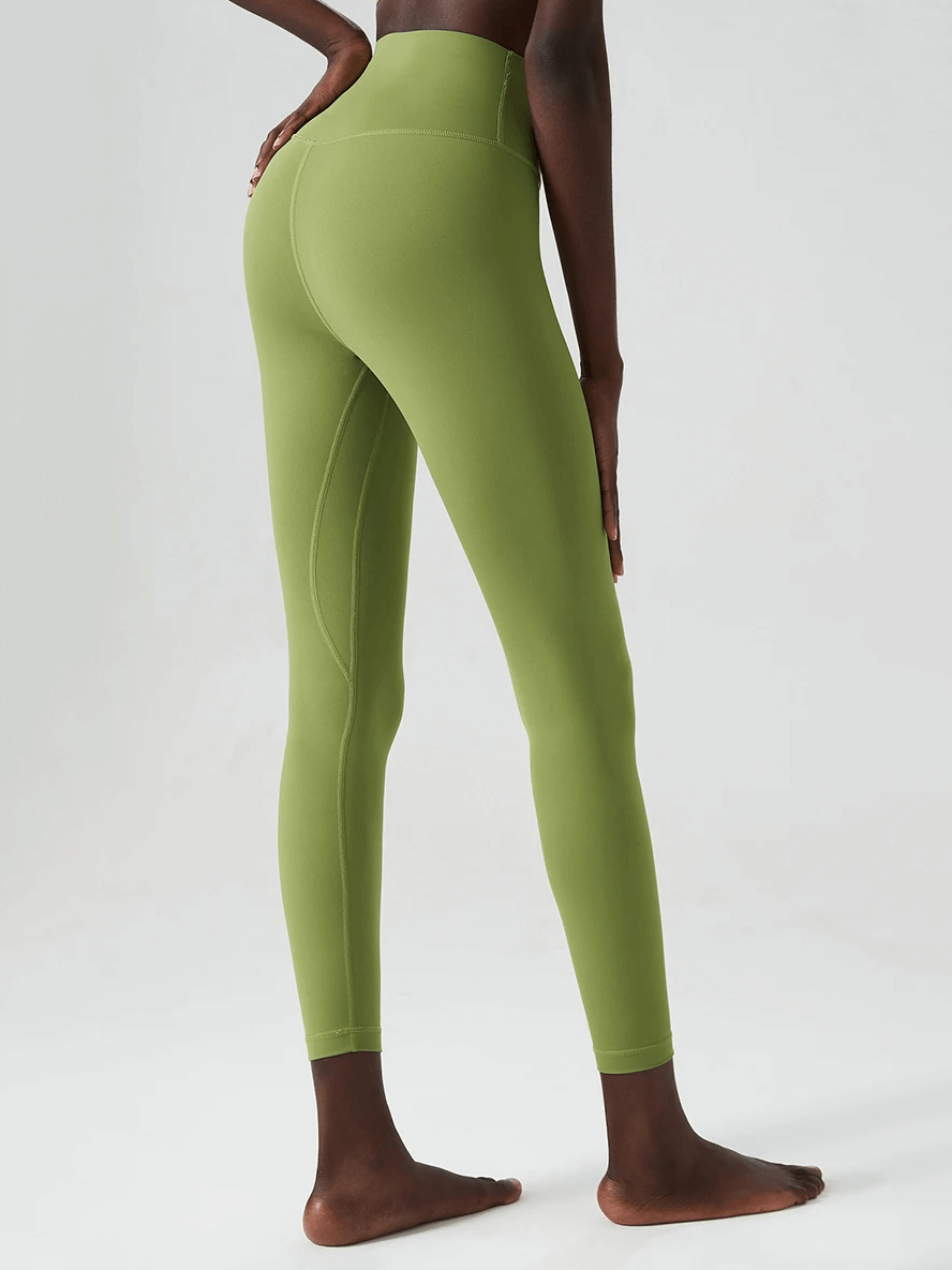 Green ankle-length yoga leggings for women, designed for versatile workouts. Perfect fit with elastic waist in durable knitted fabric.