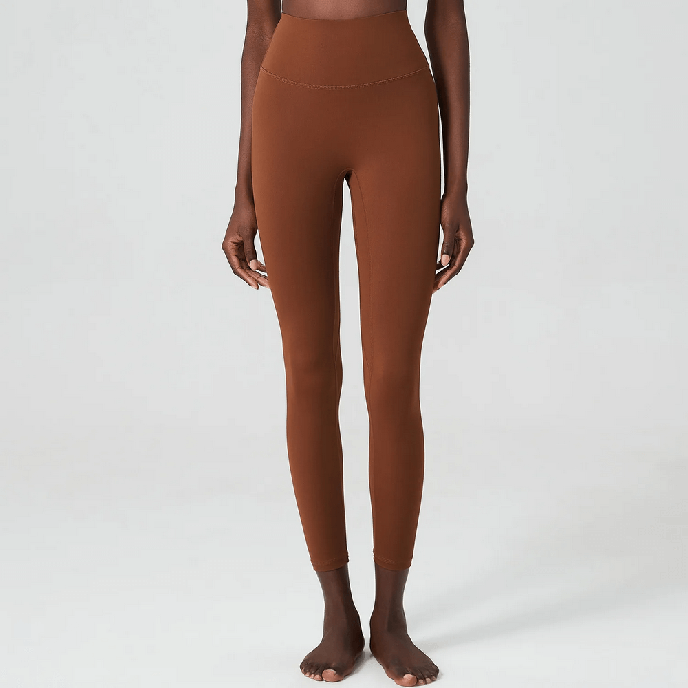 Stylish women's ankle-length yoga leggings in brown, perfect for workouts like yoga, running, and gym sessions, featuring an elastic waist.