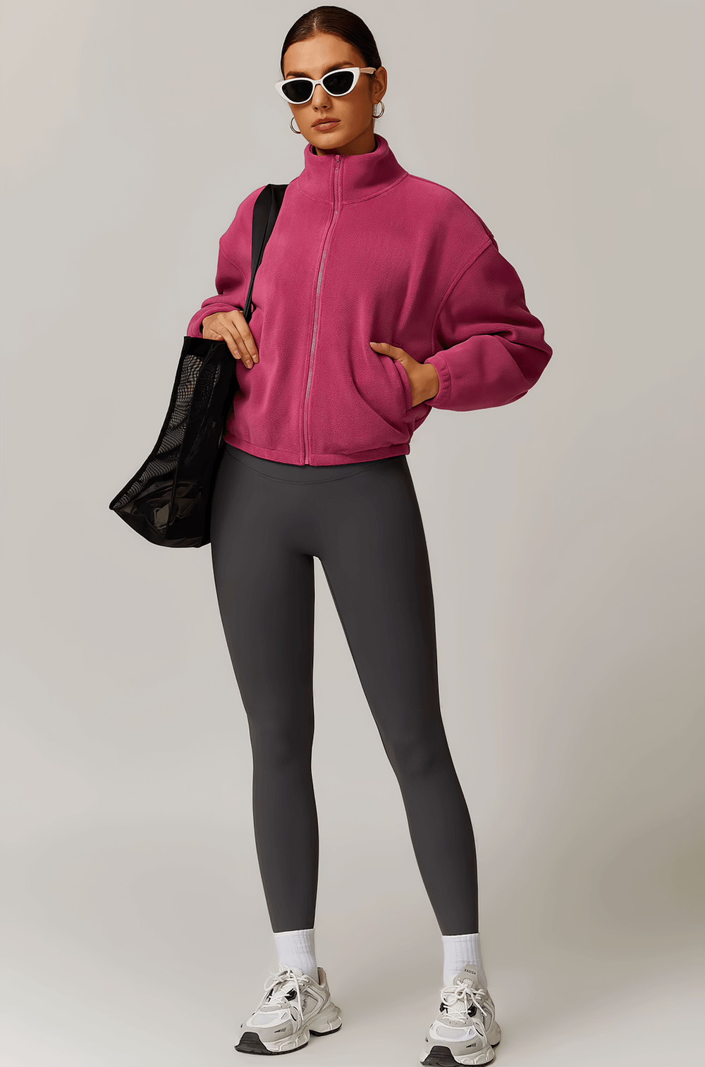 Model wearing Stylish Women's Anti-Pilling Fleece Jacket in pink, paired with black leggings and sneakers, perfect for outdoor activities.