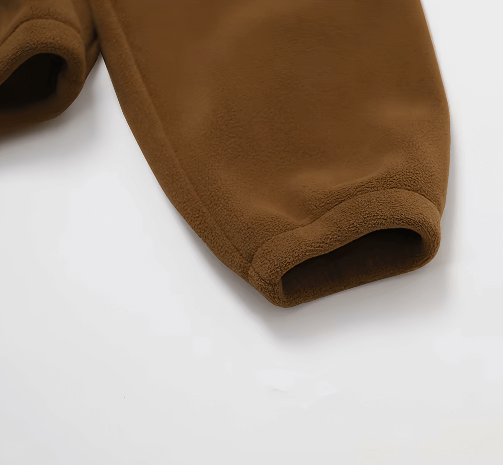 Close-up of a brown lamb fleece jacket sleeve showcasing anti-pilling fabric for durability and style.