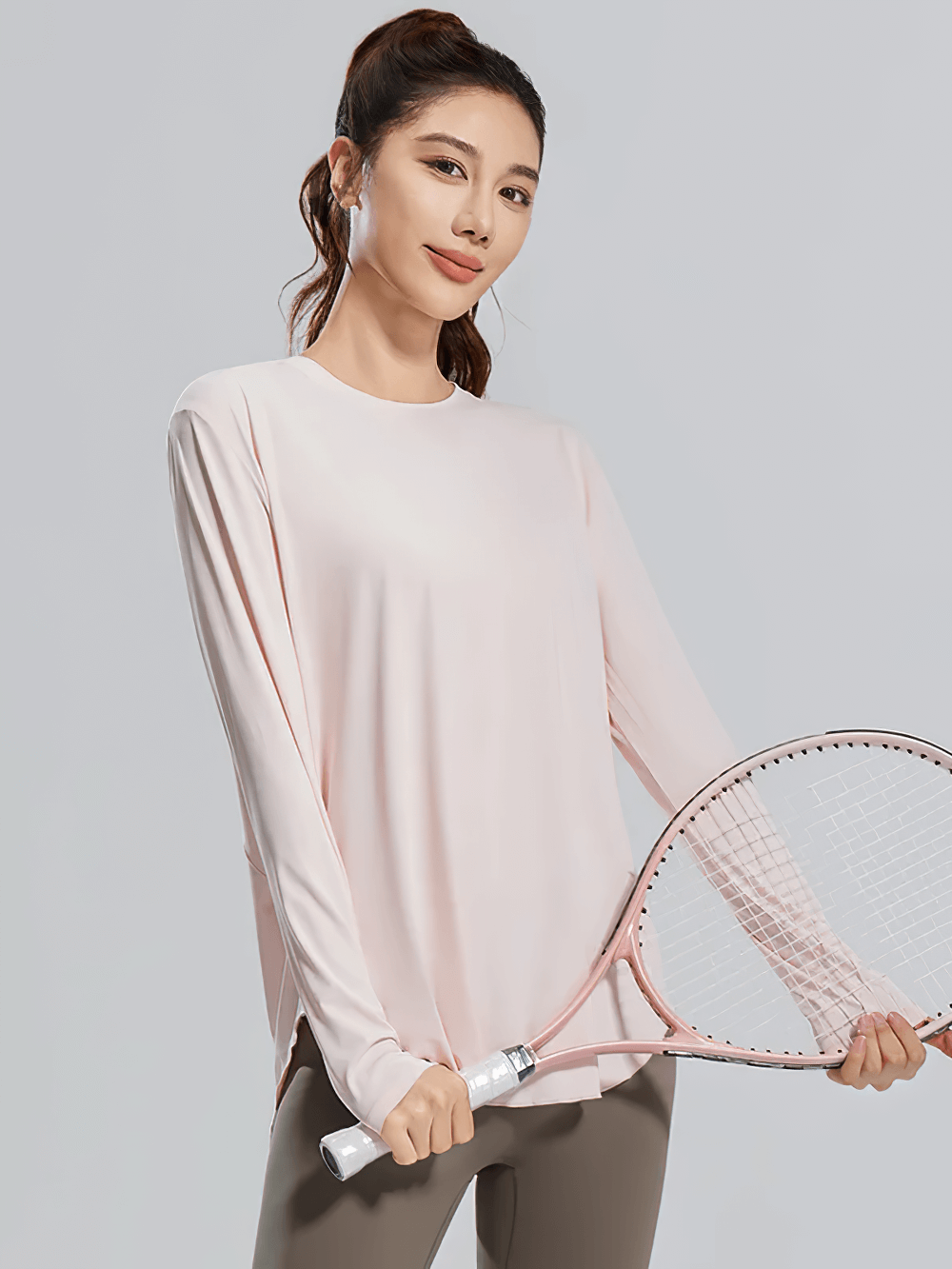 Woman in Stylish Womens Long Sleeve Top for Fitness - SF4133 holding a tennis racket, showcasing breathable and quick-dry design.