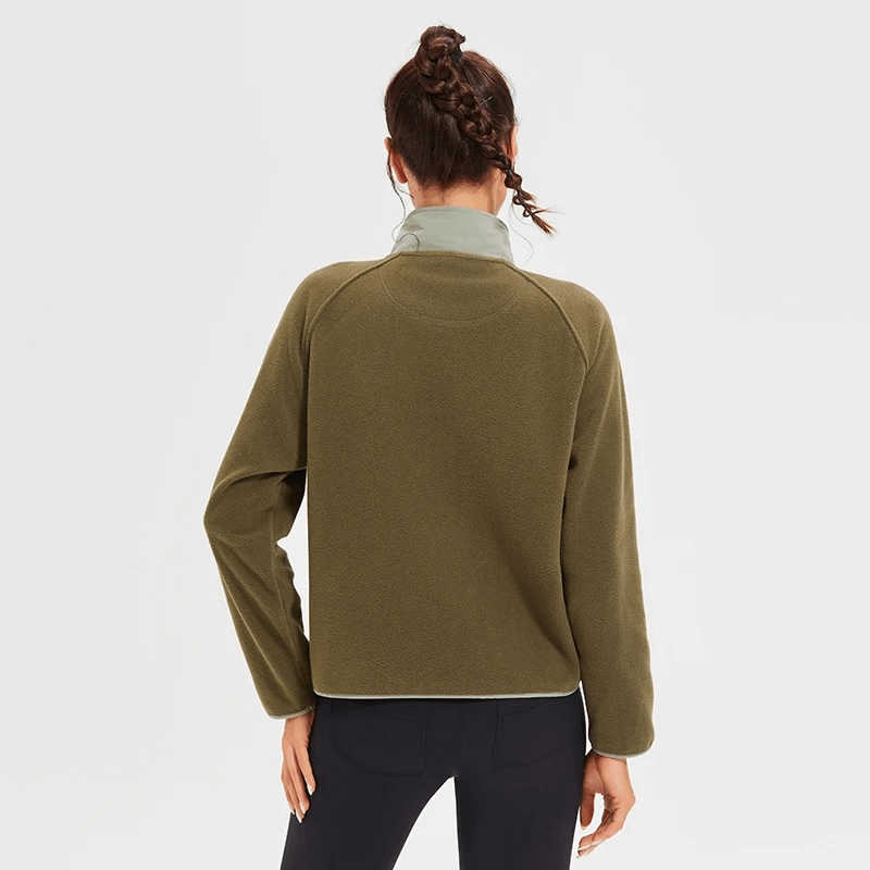 Back view of a woman wearing a stylish wool sports jacket with windproof features and a sleek mandarin collar, ideal for winter running.