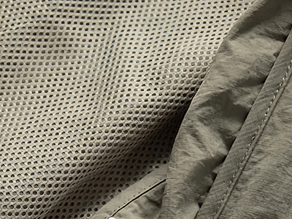 Close-up of breathable mesh fabric on tactical utility vest, showcasing durable polyester material. Perfect for outdoor and streetwear.