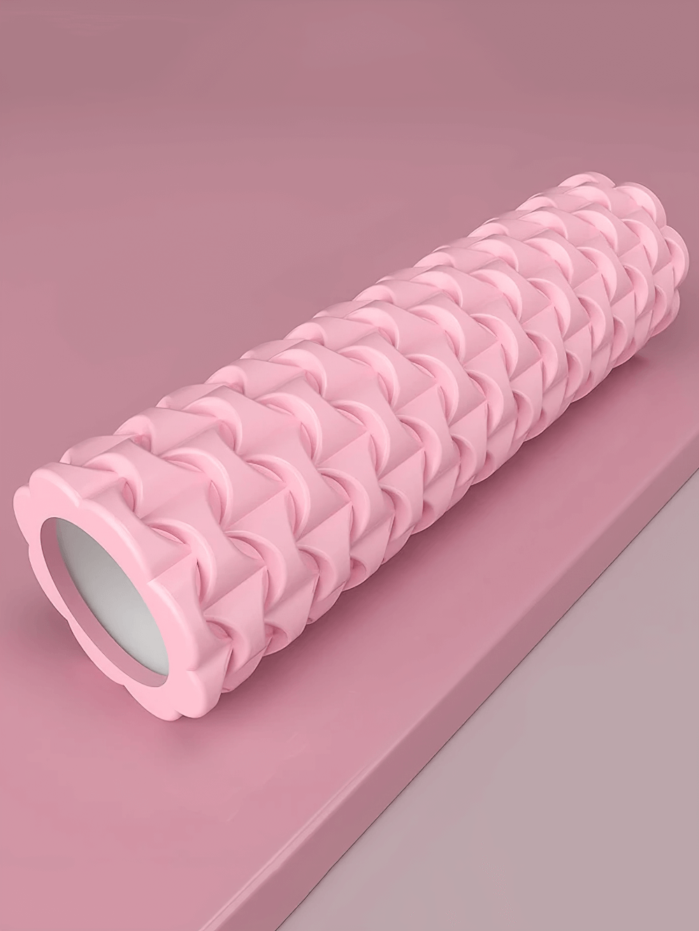 Textured pink foam roller 40cm for yoga and fitness. Ideal for deep tissue massage, muscle recovery, and improving flexibility.