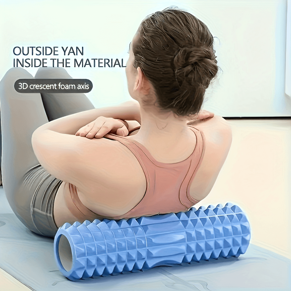 Woman using textured blue foam roller for deep tissue massage, enhancing mobility and muscle relaxation.