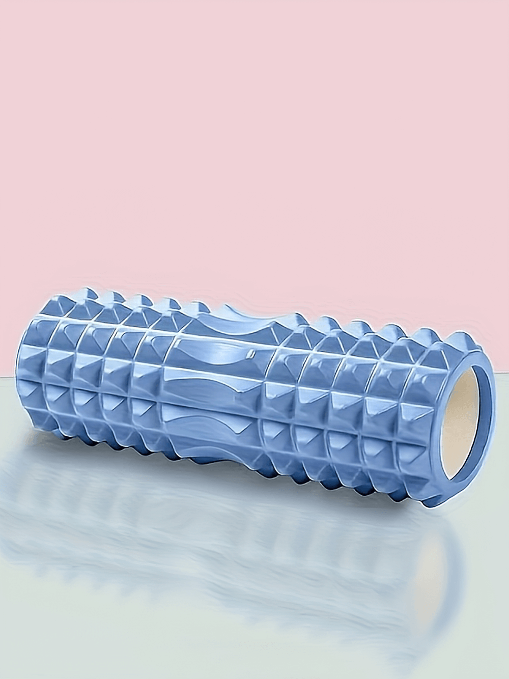 Blue textured foam roller SF2819 for deep tissue muscle massage, ideal for yoga, Pilates, and fitness recovery, on pastel pink surface.