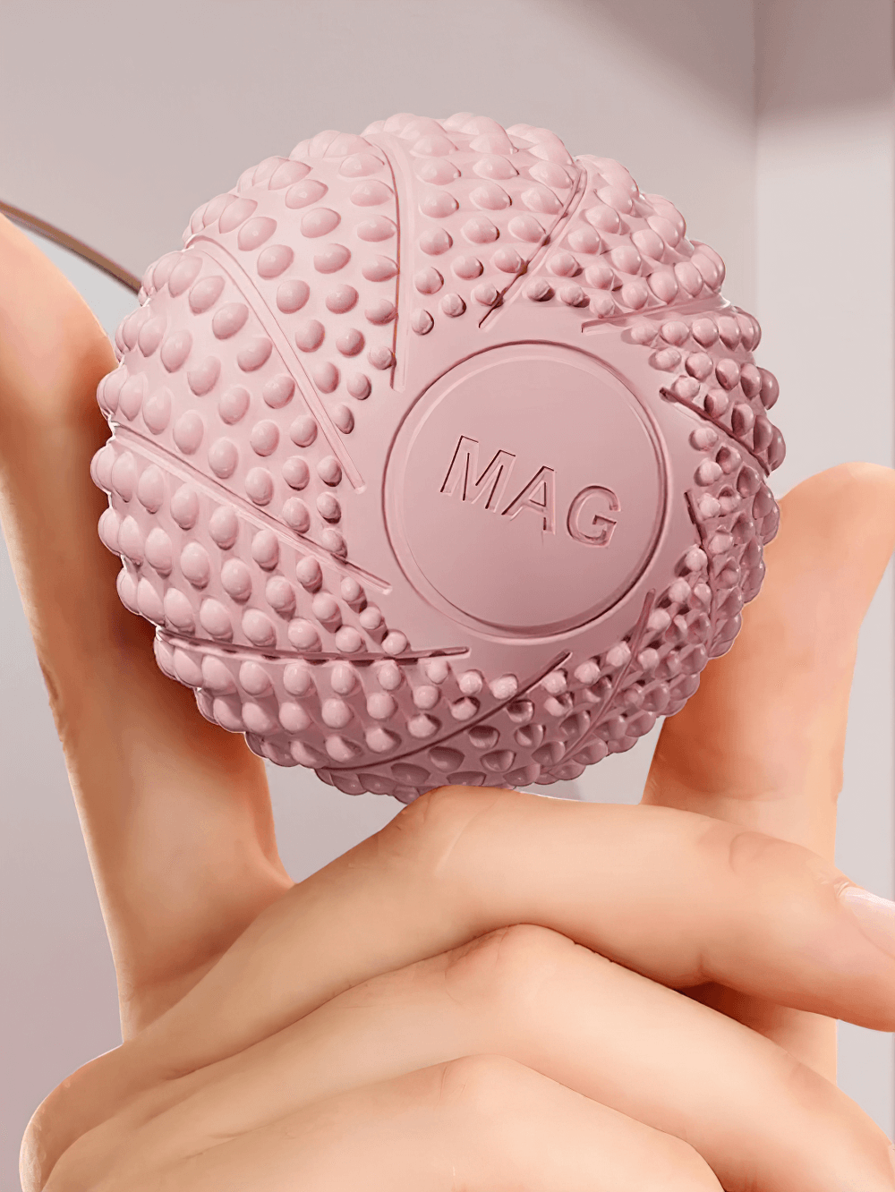 Pink textured lacrosse massage ball for muscle relief, ideal for deep tissue therapy and trigger point massage. Compact and effective.