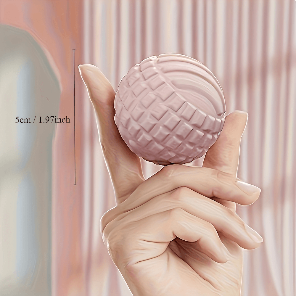 Hand holding textured massage ball for deep muscle relief, 5cm in size, ideal for foot, neck, and back pain management.