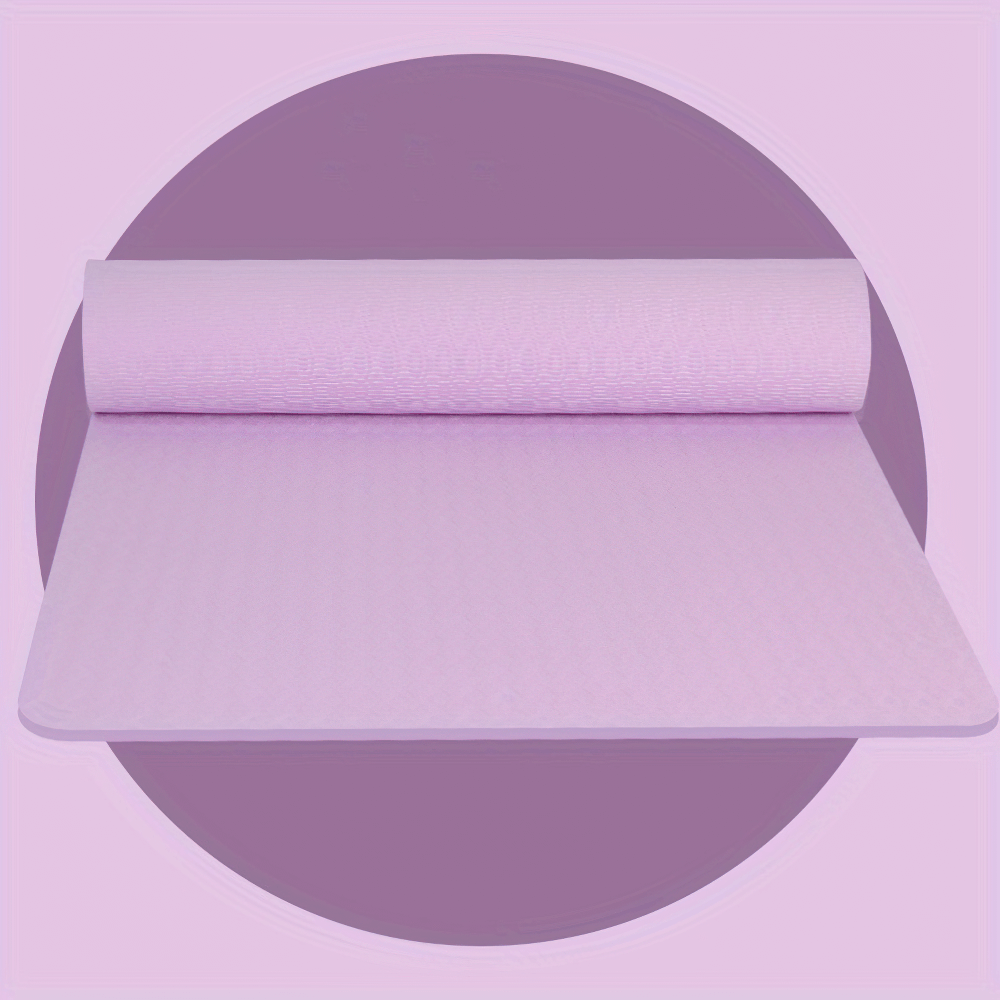 Textured pink yoga mat rolled out on purple background, ideal for grip and stability in workouts, lightweight and non-slip.