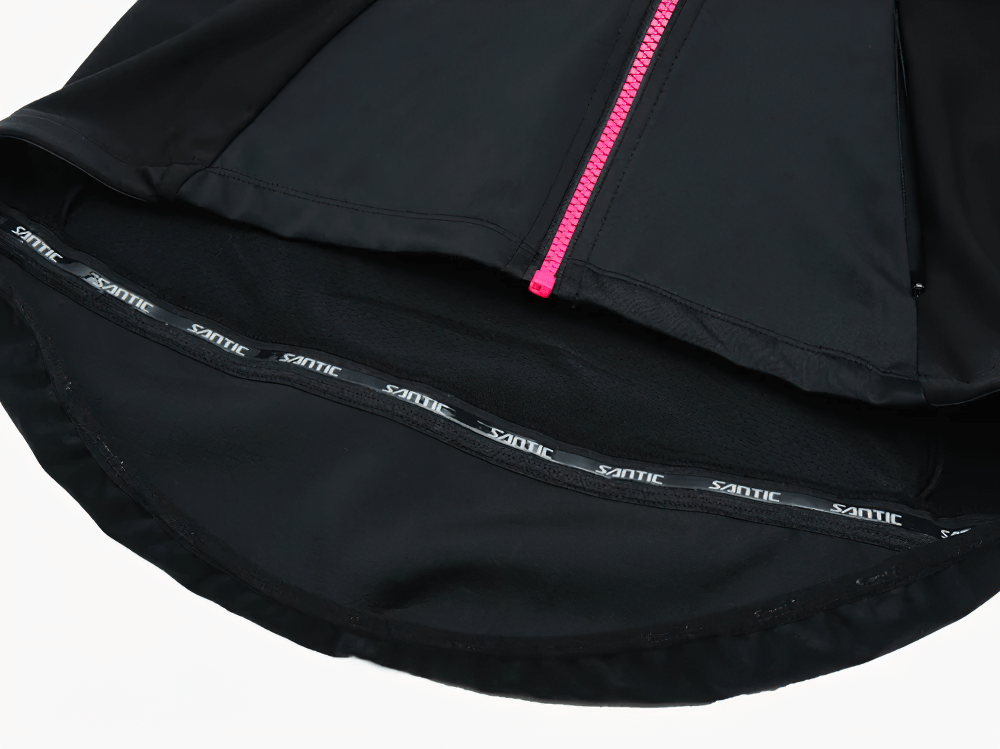 Close-up view of a black thermal cycling jersey with a pink zipper, showcasing breathable material and ergonomic design.